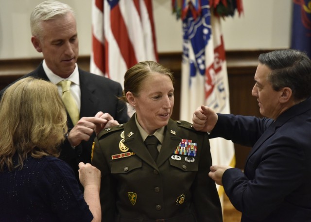 Family members of Brig. Gen. Niave Knell, U.S. Army Military Police School commandant, pin-on her new rank during a promotion ceremony June 4 at Lincoln Hall Auditorium.