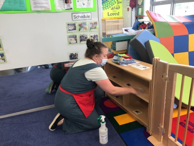 Joan Engel cleans all the surfaces in the infant room at the end of the day.  The room is cleaned with soap and water and then is sprayed with a sanitizing solution.