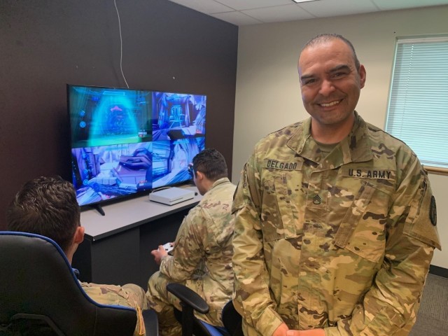 Staff Sgt. Carlos Delgado oversees Soldiers as they play a video game at the Soldier Recovery Unit in Fort Hood, Texas. (Photo via Maj. Mark Mateja)