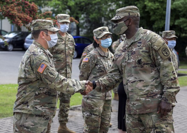 Lt. Gen. R. Scott Dingle, the 45th Surgeon General of the United States Army and Commanding General, United States Army Medical Command, coins a Soldier during a visit to Landstuhl Regional Medical Center.  Dingle made his first visit to LRMC since taking command in June 2020.