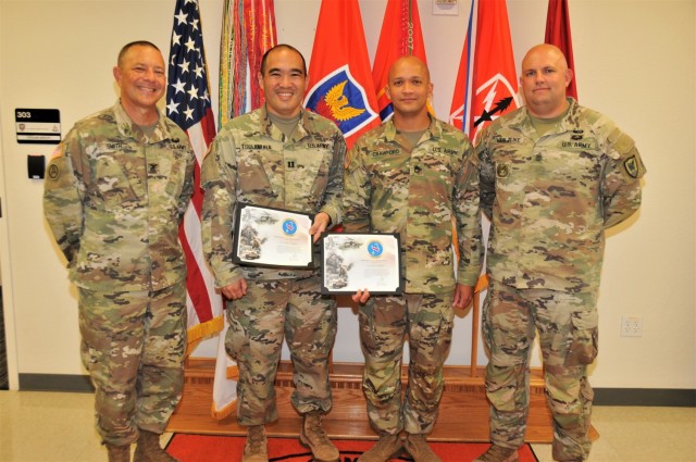 Col. Trent A. Smith (left), Capt. Jonathan R. Tsujimura (second), Sgt. 1st Class Jeremy Crawford (third) and Sgt. Maj. James W. Van Zlike (right) pose, June 8, 2021, after an awards presentation. Tsujimura and Crawford both received certificates of appreciation from U.S. Army Pacific G-2 for restoring fingerprint capability of the Secure Web Fingerprint Transmission (SWFT) program to the USARPAC G-2 section. (Official U.S. Army photo by Marc Ayalin)