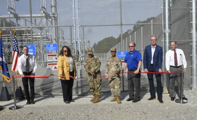 Col. Karin Watson, garrison commander, cuts the ribbon to celebrate the completion of an electrical substation located off of Sisisky Boulevard June 9. She was joined by members of her staff and those from Dominion Energy, a state utility provider...