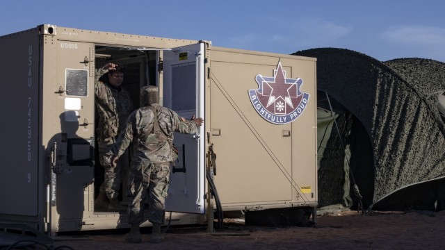 Soldiers from the 131st Field Hospital converse at the rear of their newly-stood up radiology lab on the training complex at Fort Bliss, Texas, June 5, 2021. The Guardian Knights are currently testing their ability to stand up operations in an austere environment as part of field exercise Operation Guardian Readiness.