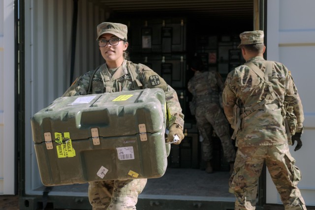 Soldiers from the 131st Field Hospital unpack a cargo container at Camp Old Ironsides, Fort Bliss, Texas, June 5, 2021. As part of field exercise Operation Guardian Readiness, Guardian Knight Soldiers stood up their Role 3 medical facility in an austere environment.