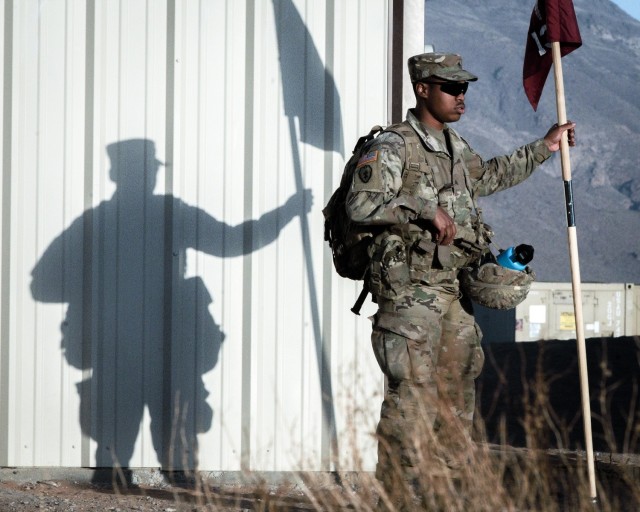 A 131st Field Hospital Soldier places the unit colors outside of the tactical operations center at Camp Old Ironsides, Fort Bliss, Texas, June 6, 2021. As part of field exercise Operation Guardian Readiness, Guardian Knight Soldiers stood up their Role 3 medical facility in an austere environment.