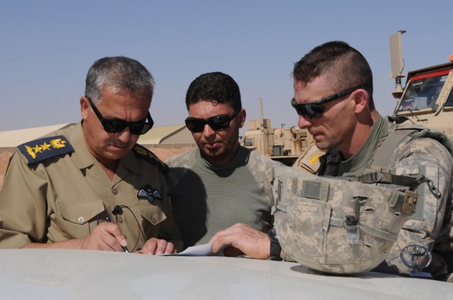 (Then) Lt. Col. Charles J. Masaracchia (right), commander of 1st Battalion 325th Airborne Infantry Regiment, 2nd Brigade, 82nd Airborne Division signs over equipment needed to build a forward area refueling point to Col. Salam al Kbaisi, air consulate, Anbar Operations Center, on an outpost in Al-Anbar, Iraq, on Oct. 10. Troopers with 2/82 have trained Iraqi Soldiers how to build, run and maintain a FARP capable of supporting aircraft. With the FARP constructed and fully functional, the ISF are now capable of operations throughout the remote portions of western al-Anbar province. 