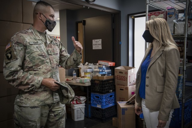 U.S. Army Sgt. Kenneth Yost, with Joint Task Force Steelhead, the Washington National Guard’s COVID-19 response force, speaks with Washington State House Rep. Tina Orwall at the Kent Food Bank, June 22, 2021, in Kent, Wash. The Washington...