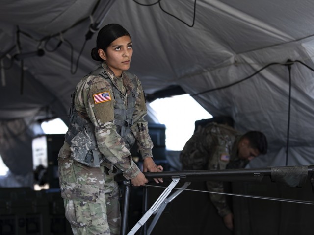 Sgt. Natalie Madrid, a 247th Medical Detachment Soldier and a licensed practical nurse, helps break out equipment during Operation Guardian Readiness, the 131 Field Hospital's latest field exercise, at Fort Bliss, Texas, June 5. During Guardian Readiness, 131st FH Soldiers are building proficiency in their ability to stand up their hospital in an austere environment.