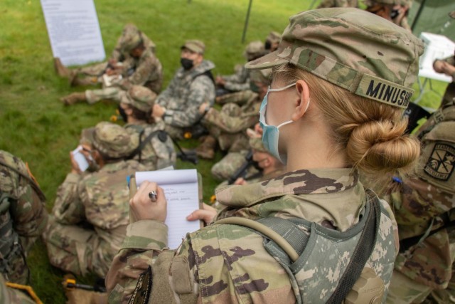 Cadets from 1st Regiment, Advanced Camp, take notes during a lecture on how to conduct a call for fire, Fort Knox, Ky., May 28, 2021. This training event takes place during the 10-day monitoring period following the arrival of each regiment where masks are mandatory.