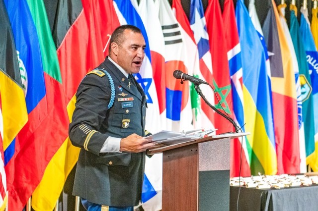 (FORT BENNING, Ga) - Twenty-Four International Military Students for 16 partner nations completed the Maneuver Captains Career Course and received their school badge in a ceremony on June 10, 2021 at the Bibb Mill Event Center.  Col. James T. McGahey, 199th Infantry Brigade commander, was the guest speaker.  (U.S. Army photo by Patrick Albright, Maneuver Center of Excellence, Fort Benning Public Affairs)