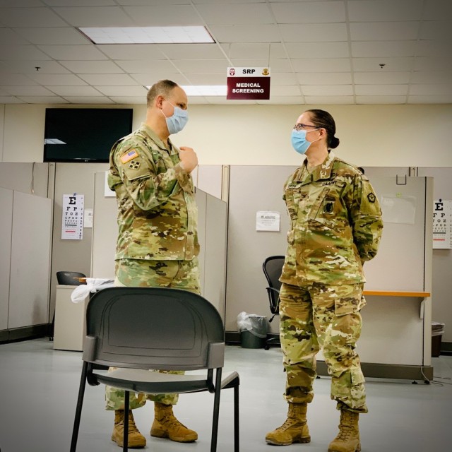 Col. Hugh McLean, MEDDAC-Ft. Knox Commander, speaks to a V Corp surgeon at the SRP mobilization site.