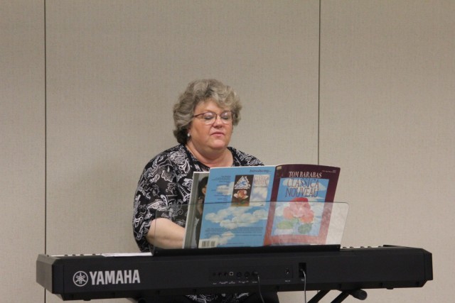 Michelle Jones, chapel pianist, provides music at the Memorial Day Prayer Luncheon, held May 27 at Fort McCoy, Wis. The Religious Support Office organizes prayer lunches for both Memorial Day and Labor Day each year. (U.S. Army photo by Aimee...