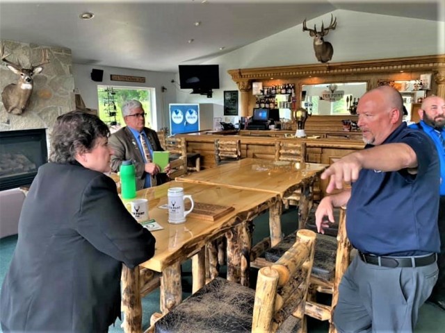 Scott Abell with the Directorate of Family and Morale, Welfare and Recreation talks with Brenda Lee McCullough, director of Installation Management Command (IMCOM)-Readiness, on June 8, 2021, at Whitetail Ridge Ski Area at Fort McCoy, Wis....
