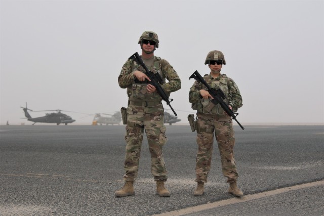 California National Guard Sgt. Daniel Gunther and Staff Sgt. Cindy Gray, both California Highway Patrol officers, pose for a photo at Camp Buehring, Kuwait. Because of their civilian law enforcement experience, they were selected to serve as the...