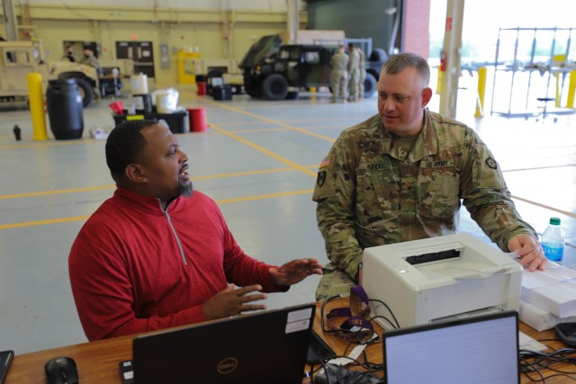 Paul Flemings, a regional manager for the United States Army Medical Materiel Agency, talks to Maj. Frank Wanat, V Corps medical logistics officer, about future V Corps missions and objectives at the V Corps Motor pool, June 2, 2021 at Fort Knox, Kentucky. The V Corps medical team received essential medical field equipment, including some of the nation’s best military grade products, to help ensure improved resiliency and quicker mental and physical healing for V Corps Soldiers.
