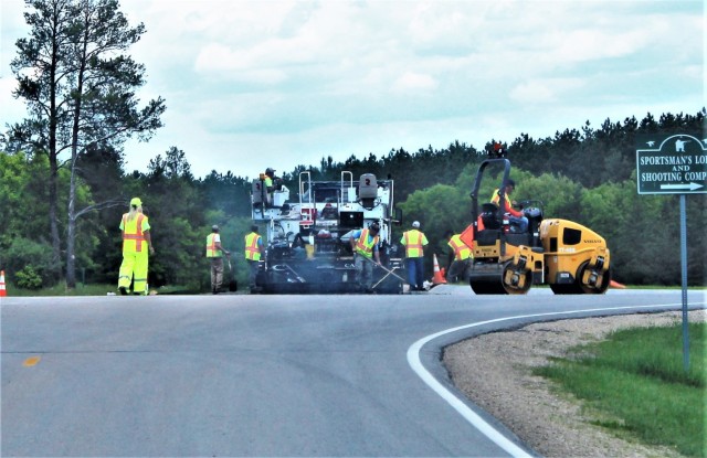 Contractors put down pavement June 2, 2021, on a road near Pine View Campground at Fort McCoy, Wis. The work is part of many types of roadwork taking place on post in 2021. The work is coordinated by the Fort McCoy Directorate of Public Works....