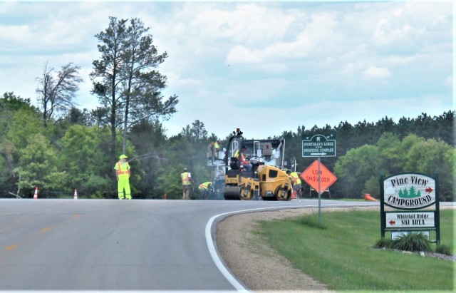 Contractors put down pavement June 2, 2021, on a road near Pine View Campground at Fort McCoy, Wis. The work is part of many types of roadwork taking place on post in 2021. The work is coordinated by the Fort McCoy Directorate of Public Works....