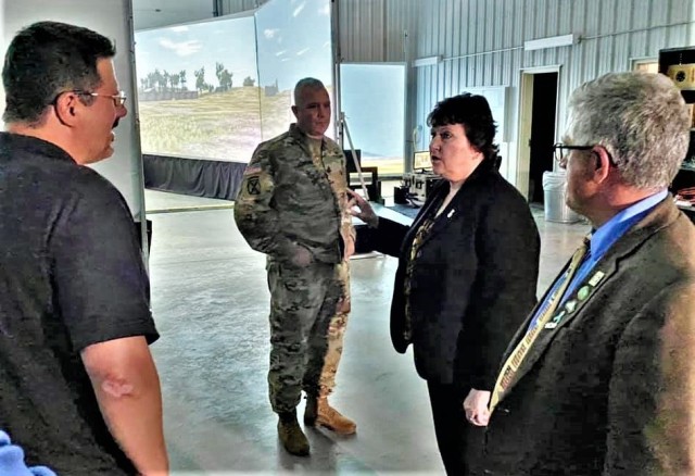 Brenda Lee McCullough, director of Installation Management Command (IMCOM)-Readiness, talks with Directorate of Plans, Training, Mobilization and Security Training Officer Rob Weisbrod on June 8, 2021, in Rumpel Fitness Center at Fort McCoy, Wis....