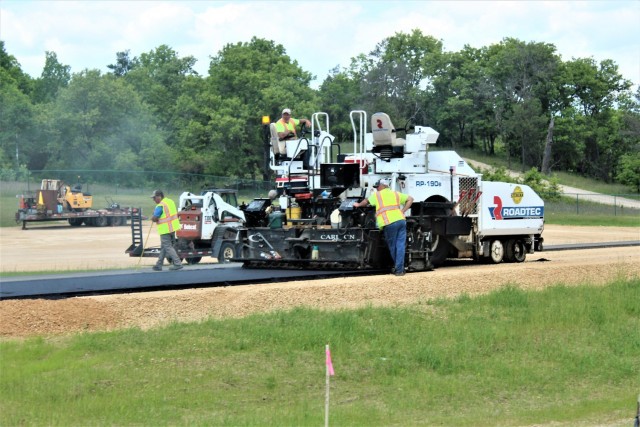 Contractors put down pavement June 2, 2021, on a road near Pine View Campground at Fort McCoy, Wis. The work is part of many types of roadwork taking place on post in 2021. The work is coordinated by the Fort McCoy Directorate of Public Works....