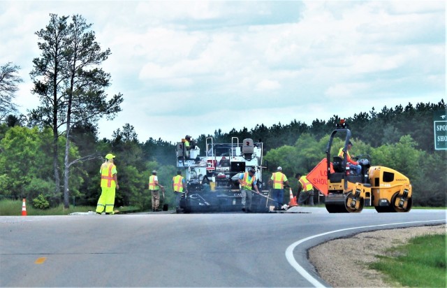 Contractors put down pavement June 2, 2021, on a road near Pine View Campground at Fort McCoy, Wis. The work is part of many types of roadwork taking place on post in 2021. The work is coordinated by the Fort McCoy Directorate of Public Works....