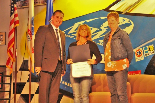 Kari Albrecht (center) is recognized May 25, 2021, by Directorate of Family and Morale, Welfare and Recreation (DFMWR) Director Patric McGuane for outstanding performance, dedication to duty, and professionalism during a DFMWR stand down event at...