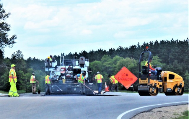 Contractors put down pavement June 2, 2021, on a road near Pine View Campground at Fort McCoy, Wis. The work is part of many types of roadwork taking place on post in 2021. The work is coordinated by the Fort McCoy Directorate of Public Works....