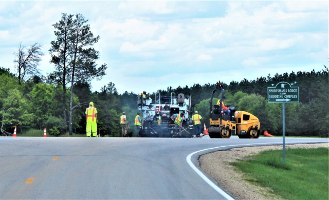 Contractors put down pavement June 2, 2021, on a road near Pine View Campground at Fort McCoy, Wis. The work is part of many types of roadwork taking place on post in 2021. The work is coordinated by the Fort McCoy Directorate of Public Works....
