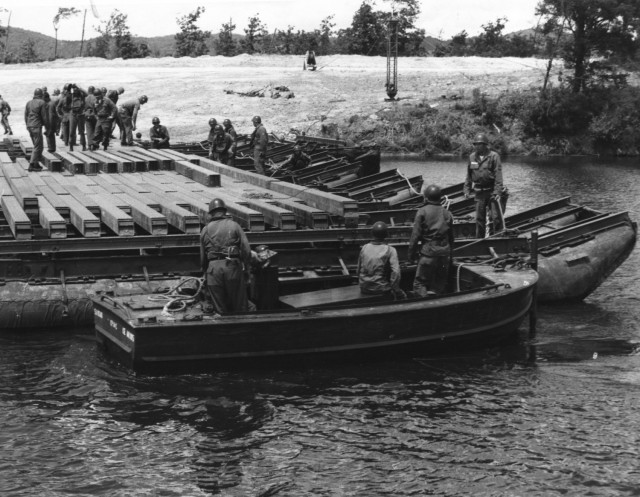 The 724th Engineer Battalion conducts bridging operations in 1960 at Camp McCoy, Wis. (U.S. Army file photo)