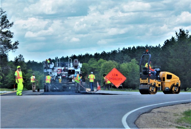 Contractors put down pavement June 2, 2021, on a road near Pine View Campground at Fort McCoy, Wis. The work is part of many types of roadwork taking place on post in 2021. The work is coordinated by the Fort McCoy Directorate of Public Works....