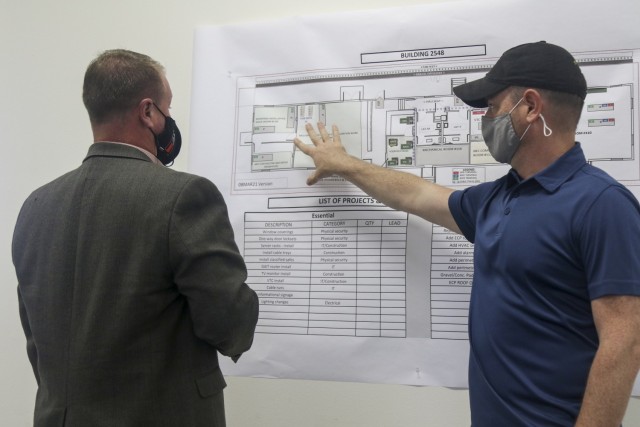 John Bowyer, right, project lead and senior network engineer, Security Applications International Corporation, explains the Mission Command Configuration Center (MC3) layout to Brandon Strait, program manager, SAIC, at Fort McCoy, Wis., April 20,...