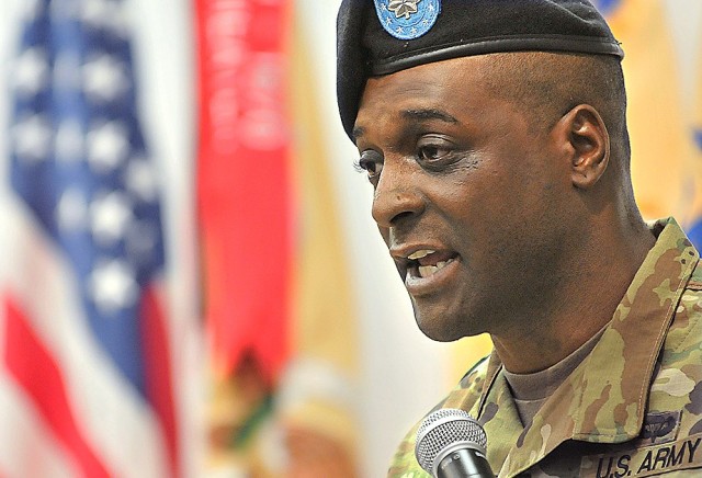 Lt. Col. Michael J. Martin Sr. makes remarks at the lectern after assuming command of the 244th Quartermaster Battalion during a change of command ceremony June 11 at Mullins Auditorium in Challen Hall.  Martin, who replaced LTC Denis J. Fajardo, comes to the Guardian Battalion from Fort Hood,Texas, where he was the Maintenance Readiness Branch Chief, Assistant Chief of Staff G4, III Corps.
