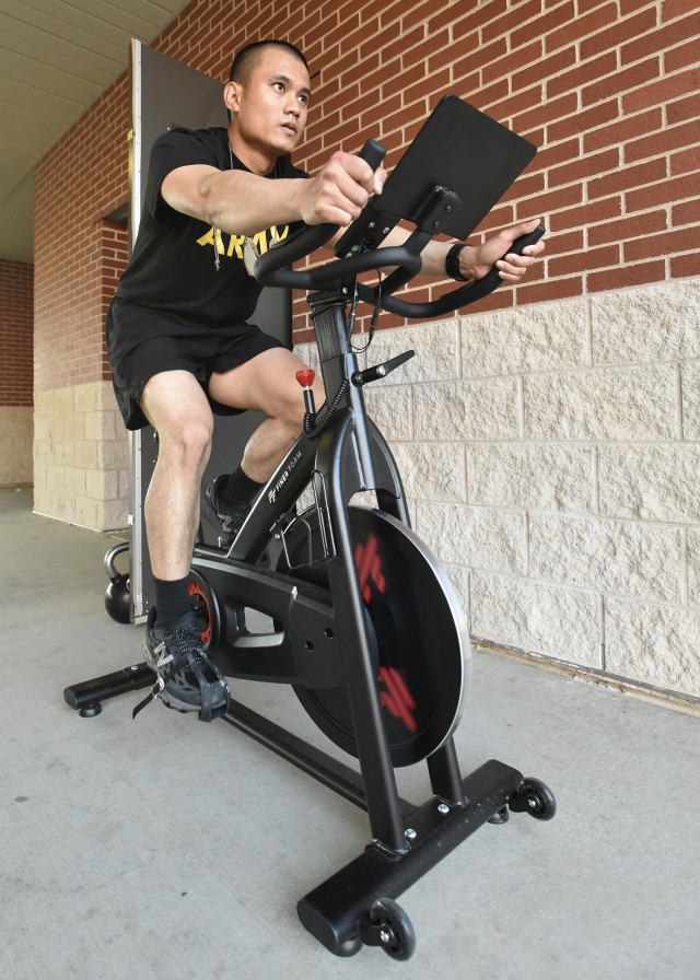 Pvt. Gian Nequila rides a stationary bike. Nequila is one of six trainees currently assigned to Company C, 35th Engineer Battalion, who perform exercises tailored to the limitations of their short-term injury profiles as part of a new program at...