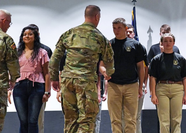 Maj. Gen. Todd Royar, the commander of the U.S. Army Aviation and Missile Command, welcomes high schooler Montgomery Hix to the Army team after administering his oath of enlistment June 7 on Redstone Arsenal, Ala.