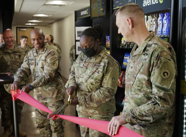 From right, Col. Joseph R. Kurz, chief of staff, 1st Theater Sustainment Command, Chief Warrant Officer 3 Denise Long, food advisor, 1st TSC, and Command Sgt. Maj. Sherman Waters, senior enlisted advisor, Special Troops Battalion, 1st TSC, cut the ribbon to open a new micro market June 14 inside Fowler Hall at Fort Knox, Kentucky. The Army & Air Force Exchange Service is supporting Soldiers and Airmen at more than 50 installations with self-serve micro markets - 100 percent contactless convenience stores - giving Warfighters round-the-clock access to better-for-you food and drink options. (U.S. Army photo by Sgt. Owen Thez)