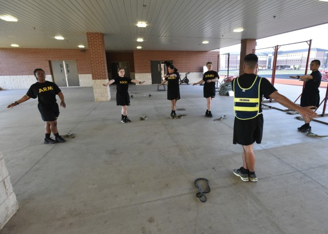 1st Sgt. Daniel Dobson, Company C, 35th Engineer Battalion, runs through a thorough stretch and recovery session with injured trainees after their workout.