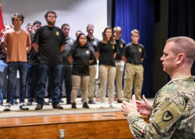 Maj. Gen. Todd Royar, the commander of the U.S. Army Aviation and Missile Command, administers the oath of enlistment to 31 high school students June 7 at Redstone Arsenal, Ala. He asked them to think about the words they were about to repeat, telling them they were pledging allegiance to the ideas that make the country great — not an individual or an institution.