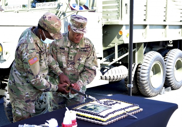 Pfc. Jasean Saunders, casualty operations specialist, 1st Theater Sustainment Command, and Sgt. 1st Class Dorris Bobb, staff movements noncommissioned officer in charge, 1st TSC, cut the cake during a ceremony celebrating the 246th U.S. Army Birthday at Fort Knox, Kentucky June 14, 2021. It is an Army tradition for the youngest and oldest Soldiers in the unit to cut the cake together, signifying the passing of knowledge from one to the other. (U.S. Army photo by Sgt. Owen Thez)