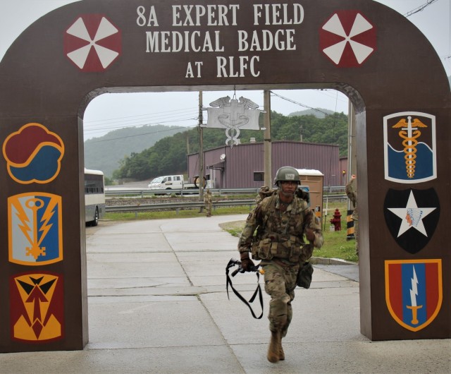 Capt. David Johnson, commander of the 75th Medical Company (Area Support), crosses the finish line of the 12-mile ruck march as part of the Expert Field Medical Badge competition, May 21, 2021, at Rodriguez Multi-Purpose Live Fire Complex, commonly known as Rodriquez Range. Johnson was one of two candidates out of over 100 to be awarded the elite badge.