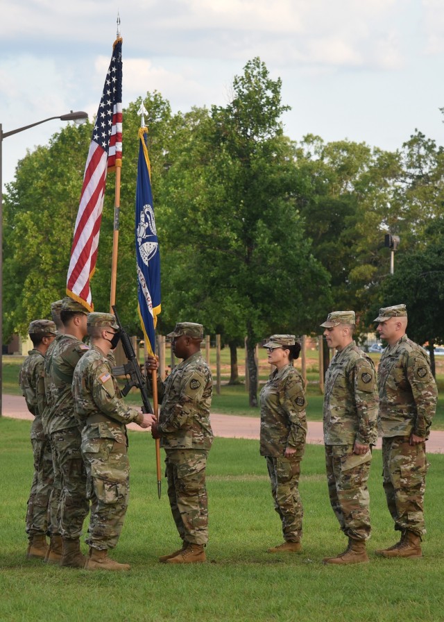 Command Sgt. Maj. Jonathan Coleman of the 2nd Cyber Battalion, U.S. Army Cyber Protection Brigade, receives the Army colors in preparation for passing them to outgoing battalion commander Lt. Col. Leslie D. Gorman (third from right) during the battalion's change of command ceremony at Fort Gordon, Ga., June 16, 2021. Gorman in turn passed the flag to brigade commander Col. John F. Popiak (right), who completed the change of command by presenting the colors to incoming commander Lt. Col. Steven R. Simmons Jr. (second from right) (Photo by. Staff Sgt. Roman Rajm)