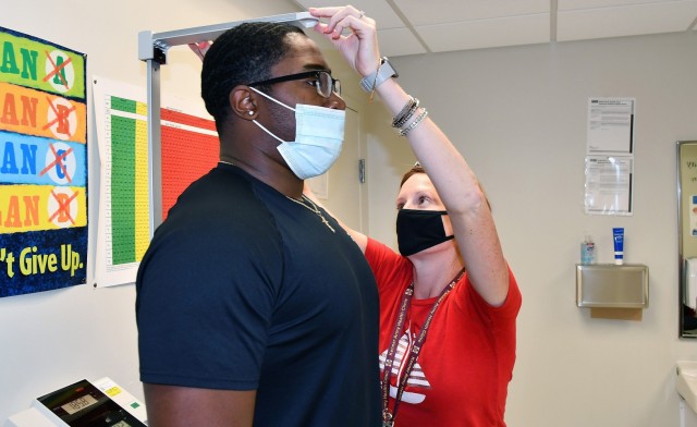 Dietitian Alison Parchesky checks the height of 17-year-old Dylan Fanial during a nutritional counseling appointment June 15 in the Family Medicine section of Kenner Army Health Clinic, Fort Lee. Parchesky and Raquel Bopp at the Active Duty Clinic...