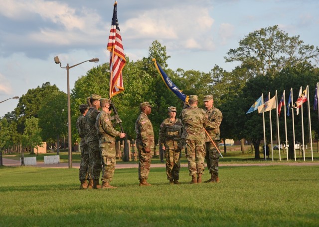 Col. John F. Popiak, commander of the U.S. Army Cyber Protection Brigade (right), passes the colors of the brigade's 2nd Cyber Battalion to incoming battalion commander Lt. Col. Steven R. Simmons Jr. during the battalion's change of command ceremony at Fort Gordon, Ga., June 16, 2021. (Photo by. Staff Sgt. Roman Rajm)