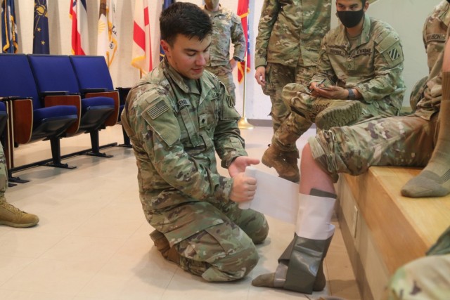 U.S. Army Spc. Orion Haener, a medic from Erie, Pennsylvania, assigned to 1st Battalion, 28th Infantry Regiment “Black Lions,” 3rd Infantry Division, demonstrates how to use a splint during combat lifesaver training on Camp Fuji, Japan, June 15, 2021. The Black Lions are in Japan to take part in Exercise Orient Shield 21-2, which begins later this month. Orient Shield is the largest U.S. Army and Japan Ground Self-Defense Force bilateral field training exercise being executed in various locations throughout Japan to enhance interoperability and test and refine multi-domain and cross-domain operations.