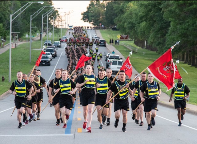 Lt. Col. Meghann Sullivan, 31st Engineer Battalionn commander (center), leads Soldiers from her battalion in the division-style Army Birthday run June 14 near Gammon Field. More than 6,000 service members took part in the three-mile run.