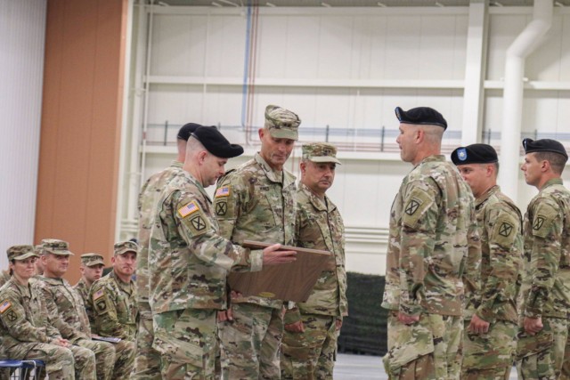 Maj. Gen. David J. Francis, U.S. Army Aviation Center of Excellence commander, presents the Lt. Gen. Ellis D. Parker award to Lt. Col. Phillip Cain, commander of 1st Battalion, 10th Aviation Regiment, 10th Combat Aviation Brigade; Command Sgt. Maj. James Bagg, 1-10th senior enlisted advisor; and Chief Warrant 4 Stace Reading, during an award ceremony June 15 at Wheeler-Sack Army Airfield. The award recognizes the Soldiers of Task Force Dragon as the top overall battalion in Army Aviation for 2020. (Photo by Sgt. Michael Wilson, 10th Combat Aviation Public Affairs)
