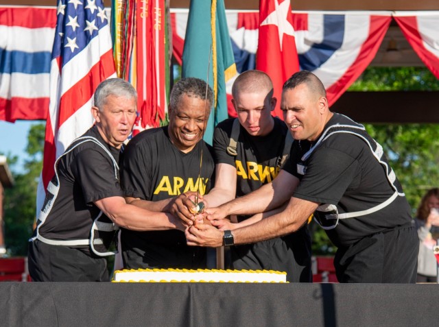 Maj. Gen. James Bonner, Maneuver Support Center of Excellence and Fort Leonard Wood commanding general (left), and MSCoE and Fort Leonard Wood Command Sgt. Maj. Randolph Delapena (right), cut the Army Birthday cake Monday on Gammon Field, with the...