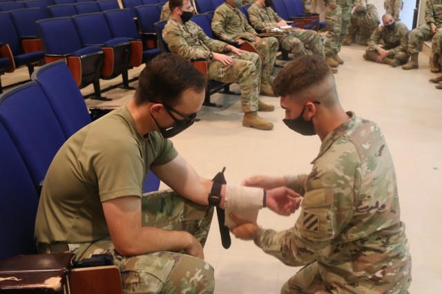 U.S. Army Pfc. Austin Wamack, infantryman from Zanesville, Ohio, assigned to 1st Battalion, 28th Infantry Regiment “Black Lions,” 3rd Infantry Division, learns how to use an emergency trauma bandage during combat lifesaver training on Camp...