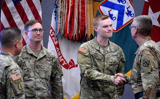 Combined Arms Center and Fort Leavenworth Command Sgt. Maj. Stephen Helton and CAC and Fort Leavenworth Commanding General Lt. Gen. Theodore Martin congratulate CAC and Fort Leavenworth NCO of the Year Sgt. Andrew Hamer, 500th Military Police...