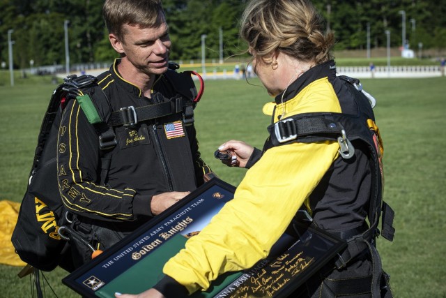 Sgt. 1st Class Joseph Abeln, the Army Golden Knights tandem team leader, presents a coin to Jenna Bush-Hager, the daughter and granddaughter of two former presidents and “Today” show co-host, after they completed a tandem jump from 10,000 feet...