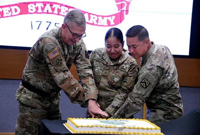 Lt. Gen. Theodore Martin, Combined Arms Center and Fort Leavenworth commanding general; Pfc. Alejandra Lopez Santiago, Munson Army Health Center; and CAC and Fort Leavenworth Command Sgt. Maj. Stephen Helton cut the Army’s 246th birthday cake...