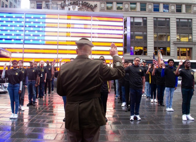 The Commandant of Cadets, Brig. Gen. Mark Quander, conducts an enlistment ceremony to swear in 46 new Soldiers into the U.S. Army during the 246th Army Birthday celebration Monday at Times Square in New York City.